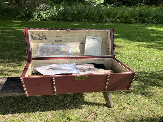A traveler's trunk with items inside.