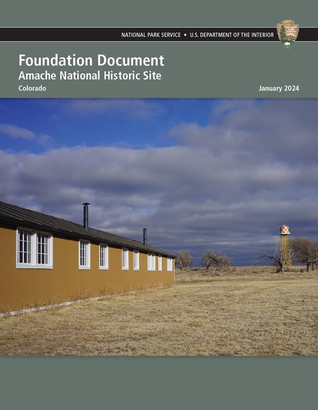 Cover page of a document. Text reads "Foundation Document, Amache National Historic Site, Colorado, January 2024." Beneath the text is an image of a historical barracks building in a field with sparse trees and a large water tower.