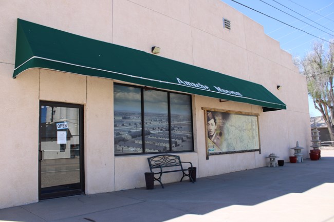 A building with an awning reading "Amache Museum."