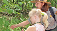 A park ranger helping a girl