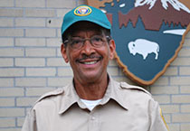 smiling man with cap and glasses
