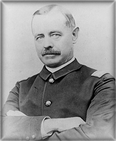 Black and white photo of gentleman with thinning hair and arms crossed in Union military uniform from Civil War era.