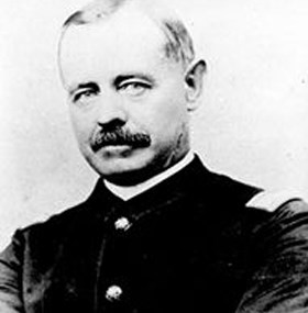 Head and bust photo of middle-aged man with thinning hair and moustache wearing a Civil War lieutenant's Union uniform. He is looking at the camera with a bit of a side glance.