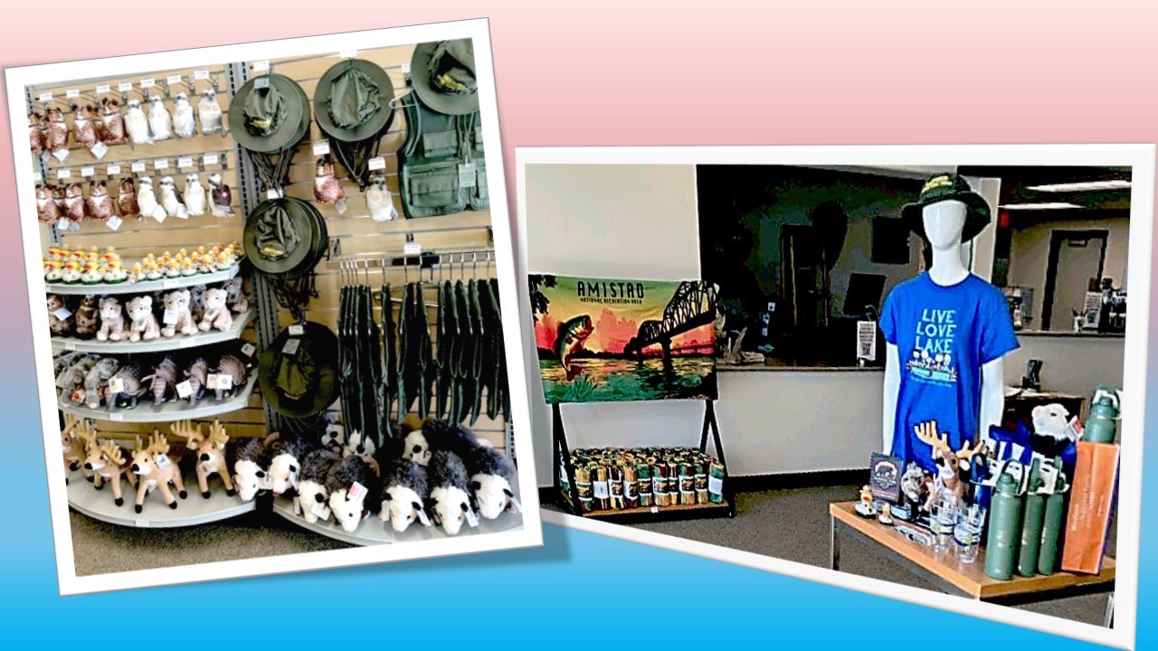 Stuffed animals and junior ranger gear, Amistad National Recreation Area towels with image in sunset tones, mannikin torso wearing Amistad t-shirt and Junior Ranger bucket hat surrounded by water bottles and other souvenirs.