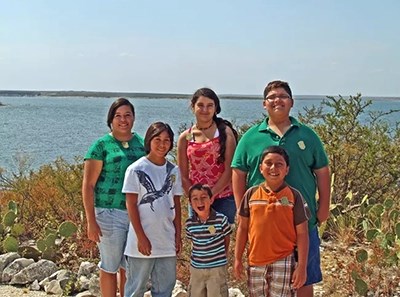 Group of 6 Jr Rangers of various ages in front of Lake Amistad