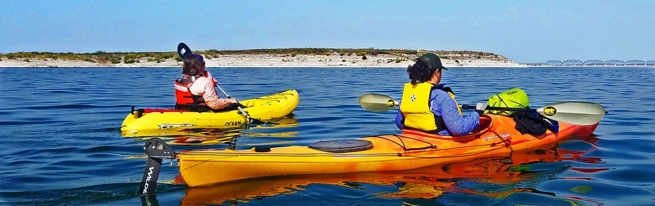 Two people kayaking through the lake
