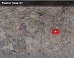Faint, red-painted petroglyphs depicting anthropomorphs on a Panther Cave wall.