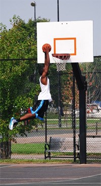 A man defies gravity and and dunks a basketball. A man defies gravity and and dunks a basketball.