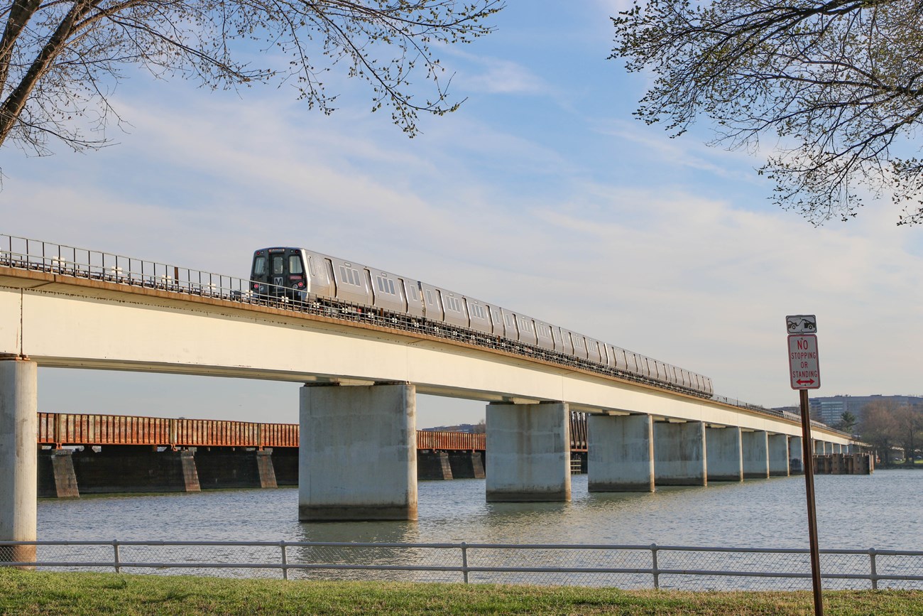 A metro train crosses a river