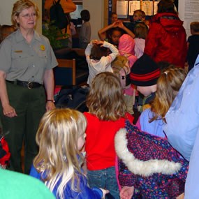 Park Ranger gathers children for wildlife etiquette activities Park Ranger gathers children for wildlife etiquette activities