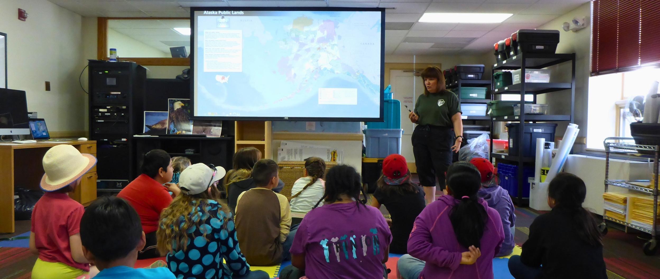 Ranger presenting to students in the Anchorage Alaska Public Lands Information Center classroom