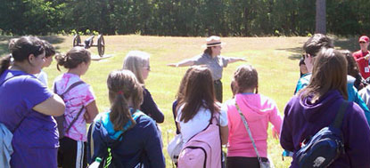 Park ranger discussing earthwork defenses with students.