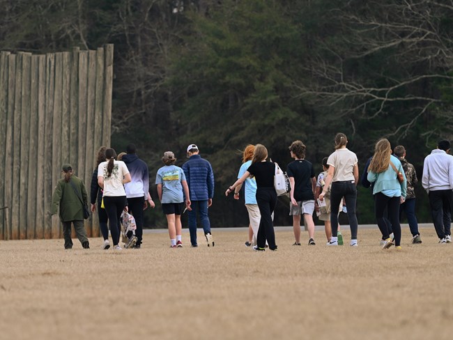 Park ranger giving a group of students a tour while leading them to Shelter Corner.