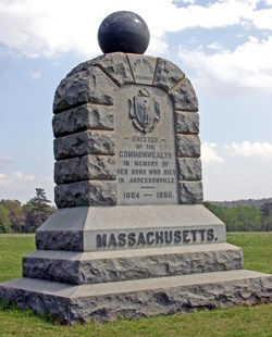 Stone monument in a grass field setting