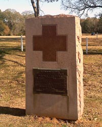 Stone monument featuring a red cross design Stone monument featuring a red cross design