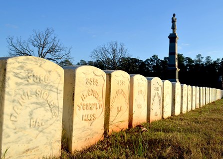 Sunset lights a row of headstones