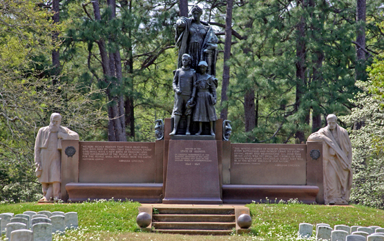 Monument with stone and broze statue figures in the spring