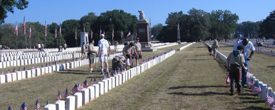 Scouts and leaders placing flags in the National Cemetery Scouts and leaders placing flags in the National Cemetery