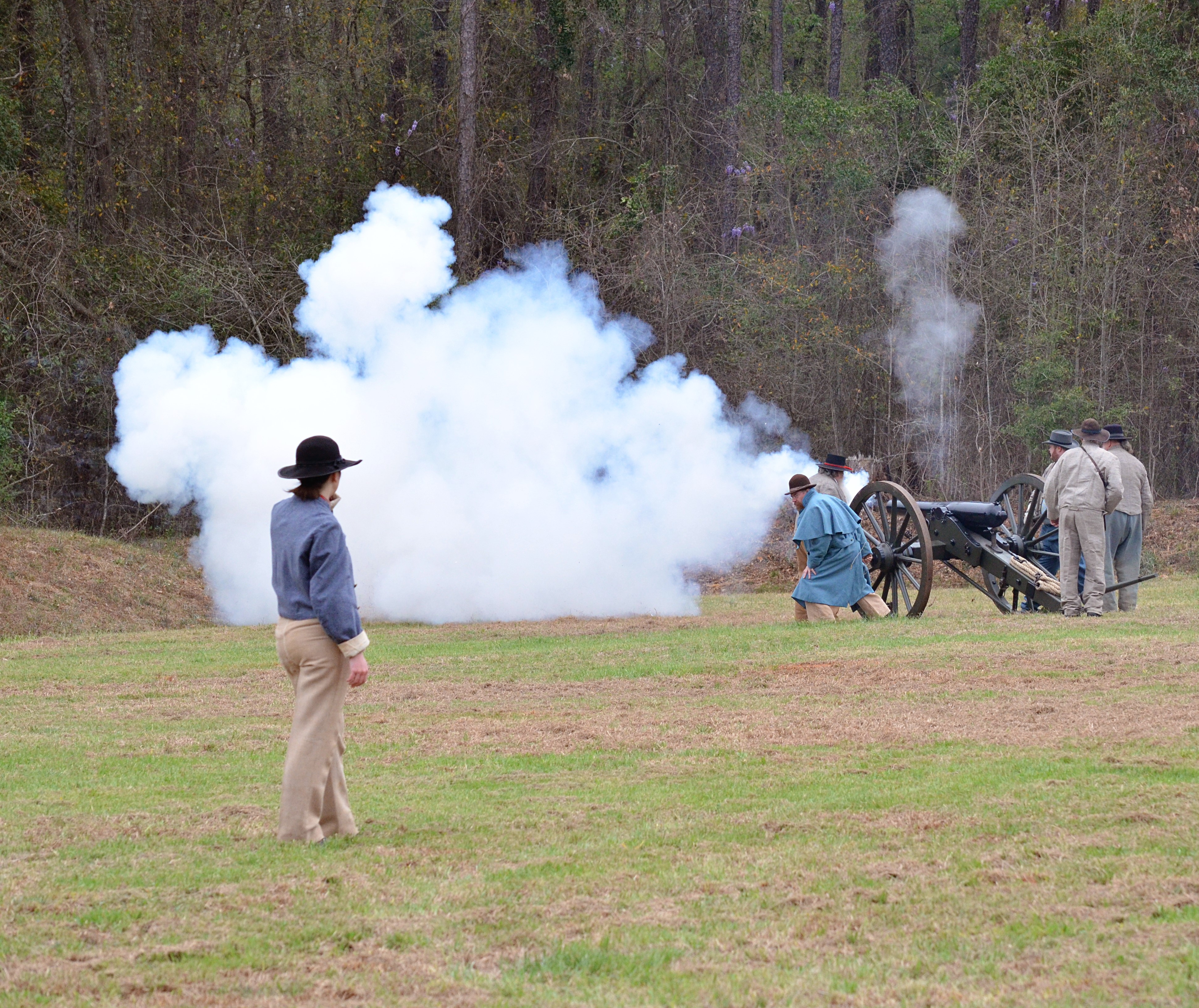 Cannon crew fire cannon with smoke.