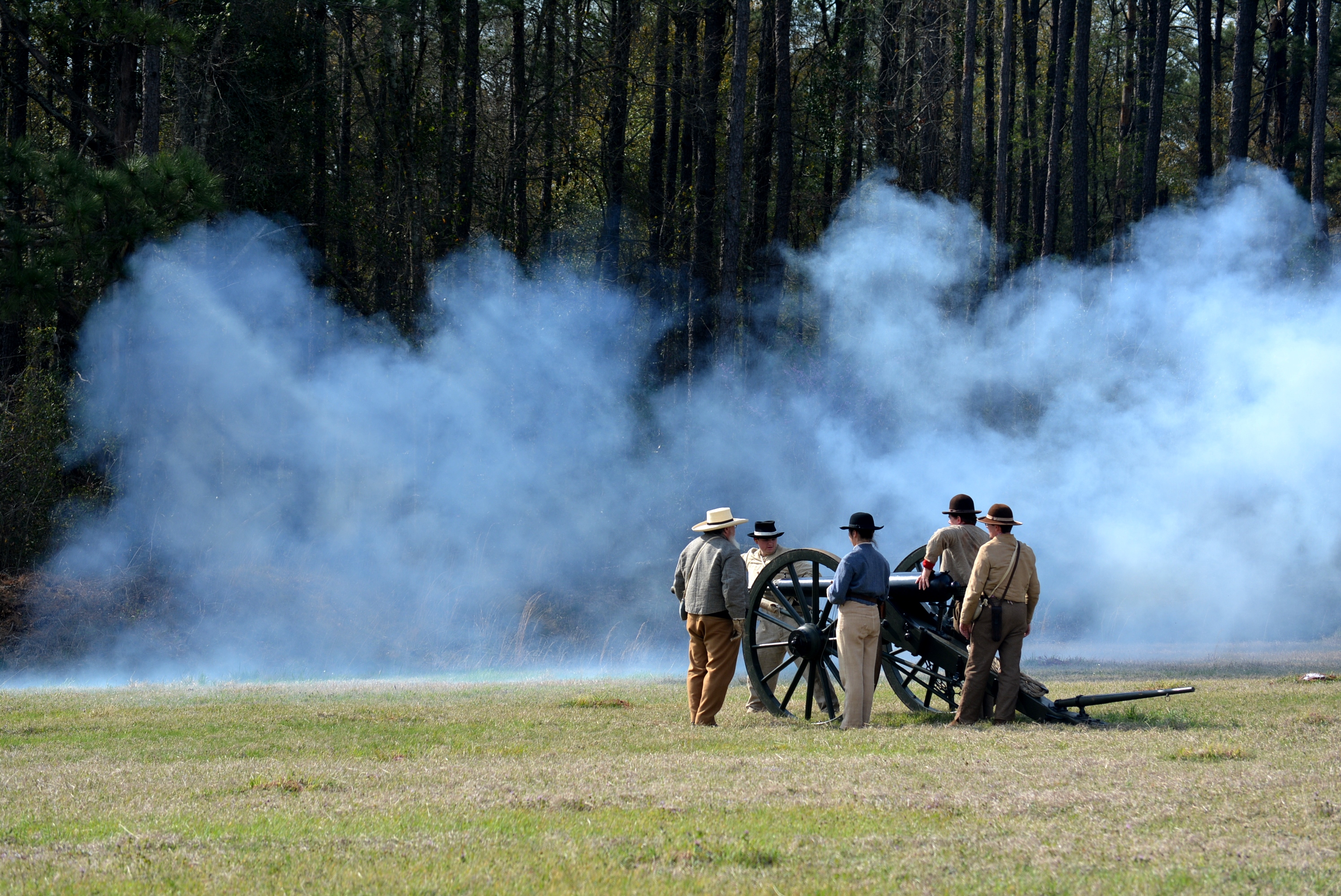 MicrosoftTeams-image (6) Men in uniform firing cannon, smoke can be seen in the background