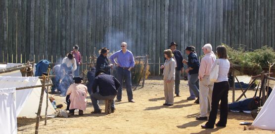 Men dressed as Civil War soldiers talk to visitors