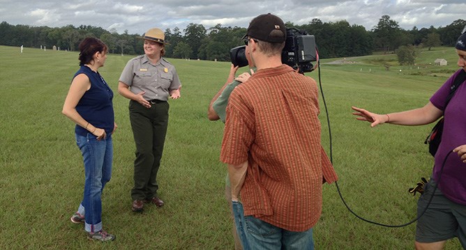 Park ranger works with a camera crew