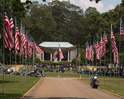 American Flags lining a road to a memorial structure