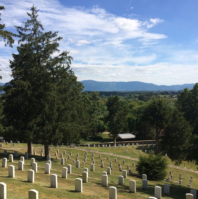 Cemetery view of gravestones and mountains