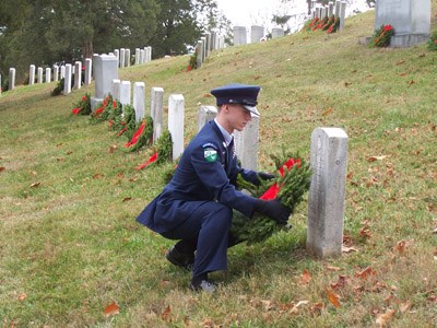 High School ROTC student lays wreath on grave of fallen hero