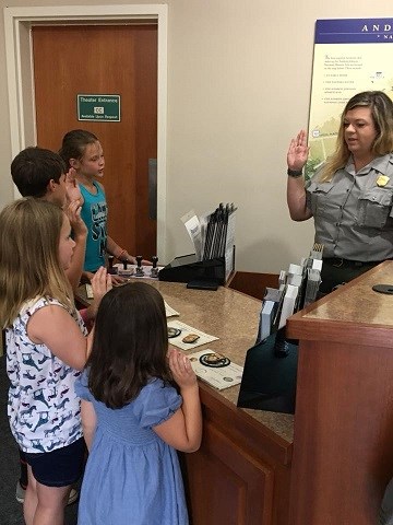 A ranger swears in new junior rangers