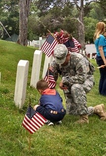 Scouts place flags on veteran graves for Memorial Day Flags for Memorial Day
