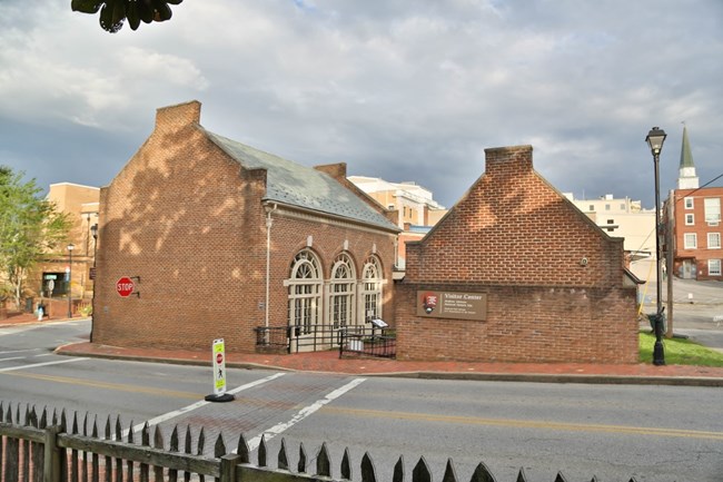 A view of the Visitor Center from the Early Home yard looking across College Street