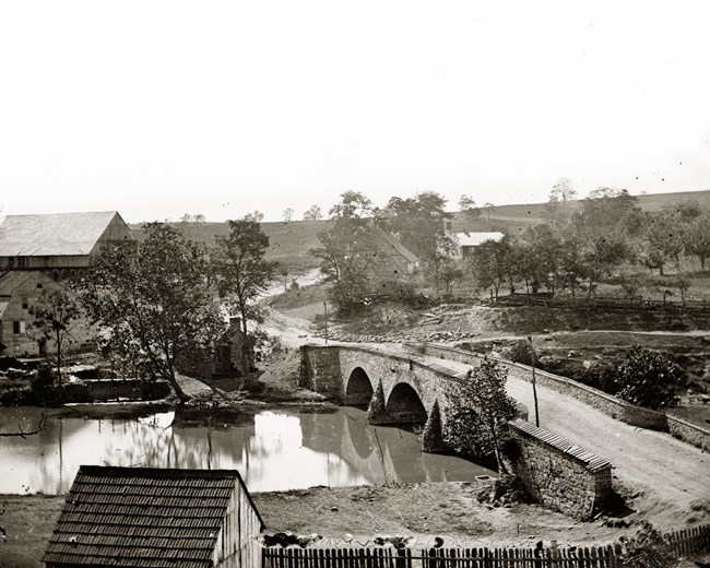 stone bridge over antietam creek buildings in background