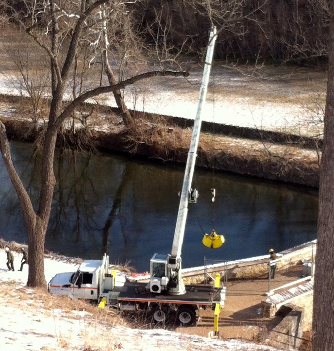 Crane pulling up stones