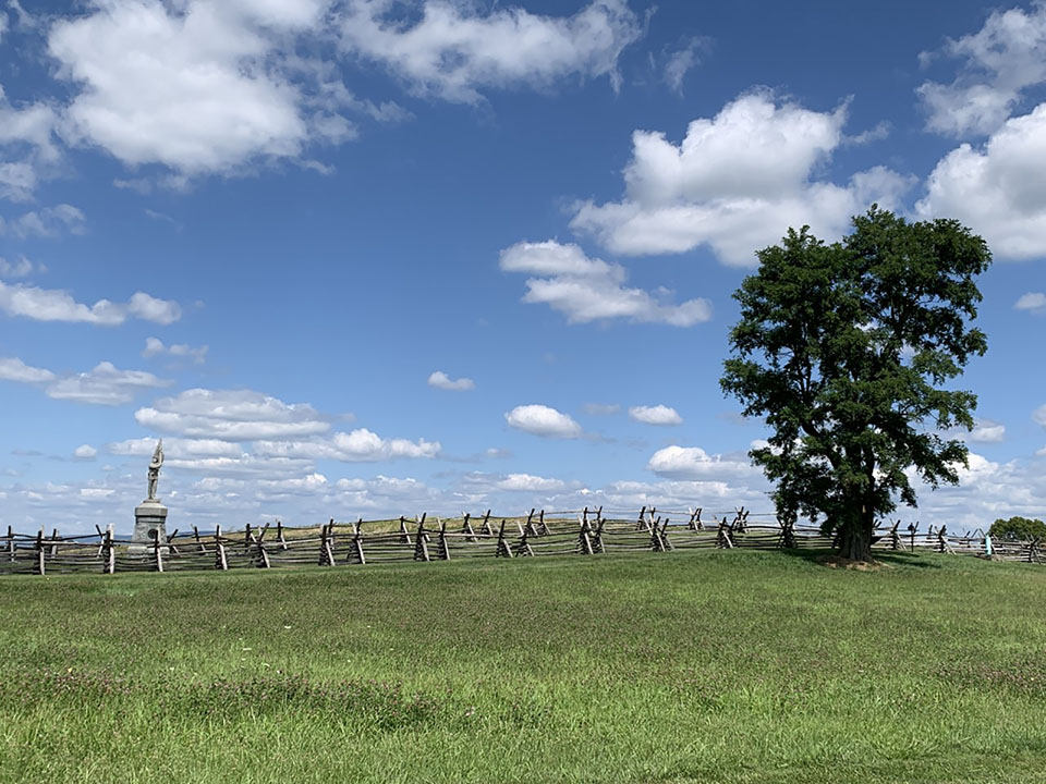 fence monument clouds in sky