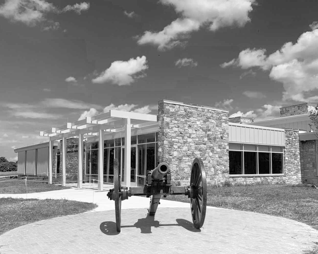 cannon sits near entrance of stone visitor center