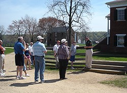 Volunteer In Parks (VIP) Warren Taylor gives a village tour.