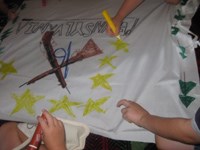 Children making a regimental flag during a summer camp activity.
