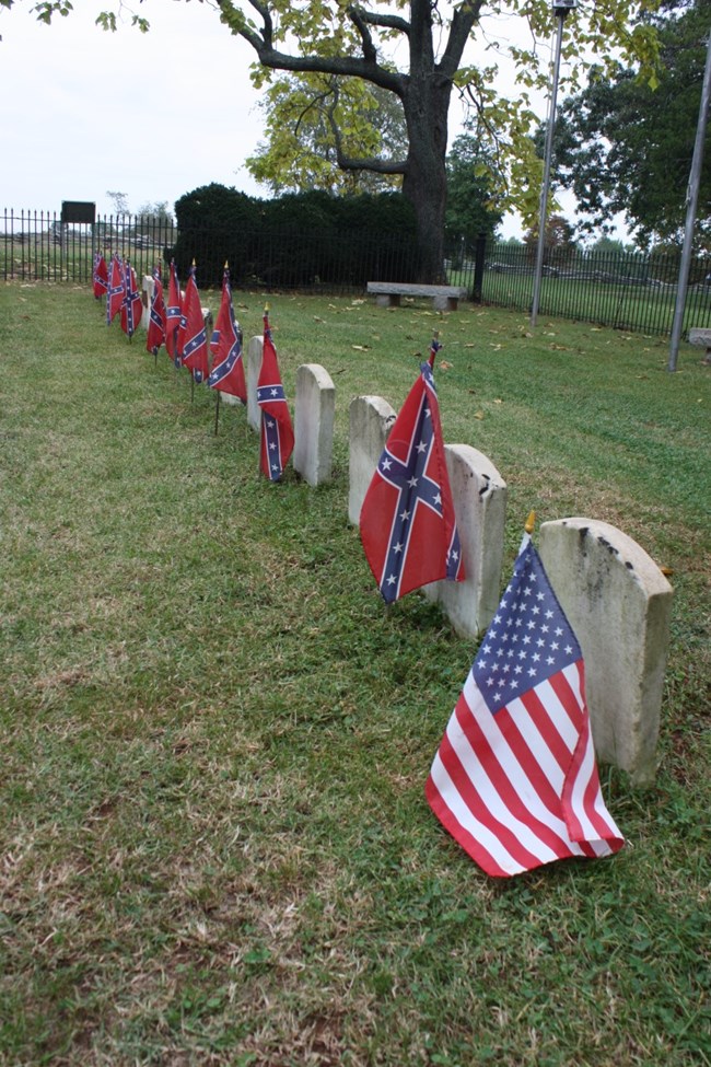 The Confederate Cemetery is a straight row of grave markers with one Union soldiers grave and the rest Confederate