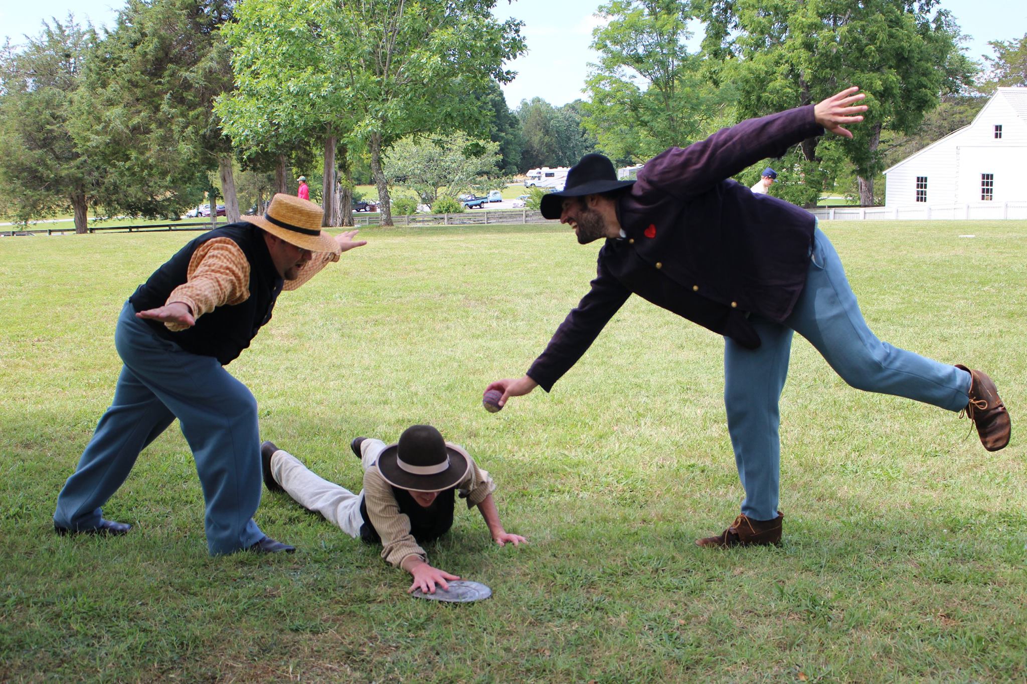 Three men playing baseball in Civil War attire.