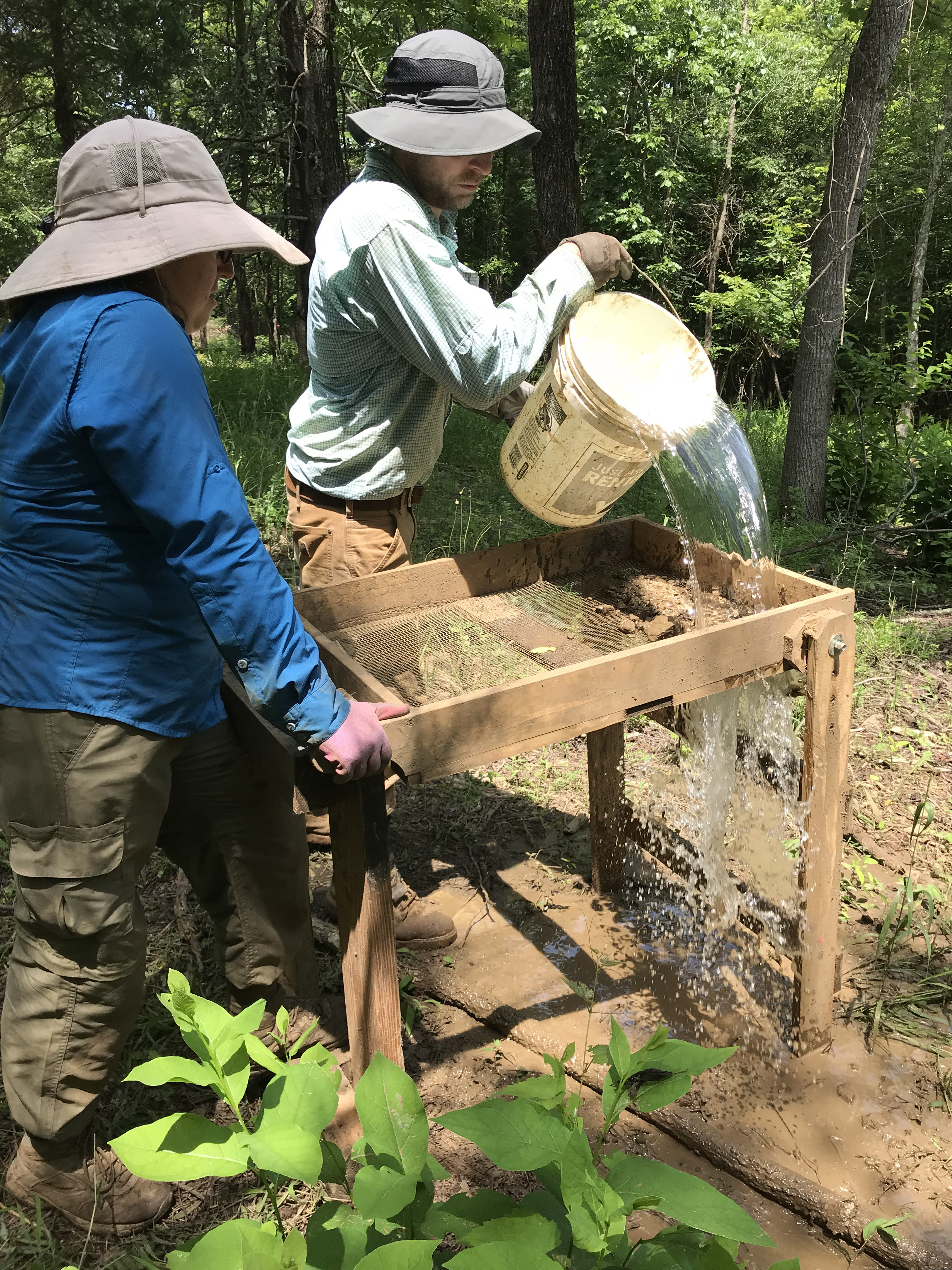 Project lead, Dr. Kevin Fogle and Field Director, Dr. Kelly Goldberg employ water screening techniques to find artifacts in the waterlogged clay soils.