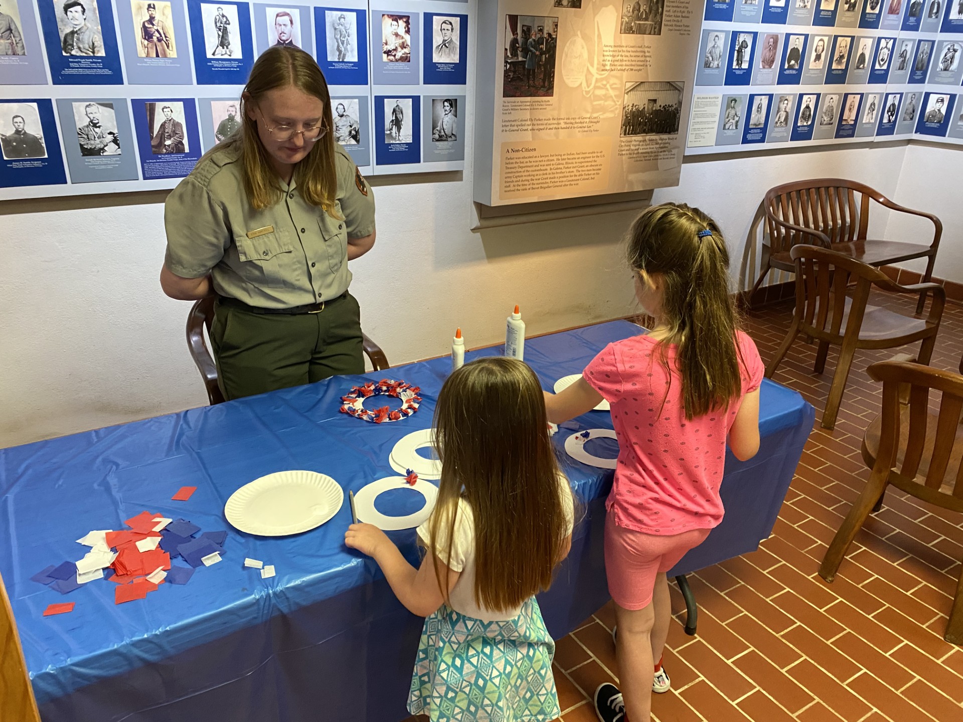 Wreath decorating Two young girls decorate their own wreaths with the assistance of a park ranger