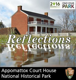 McLean House reflected in a puddle after a rainstorm.