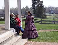 An actress portraying Mrs. George Peers converses with park visitors. An actress portraying Mrs. George Peers converses with park visitors.