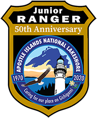 Junior Ranger badge sticker A badge showing Lake Superior, an eagle, lighthouse and trees.