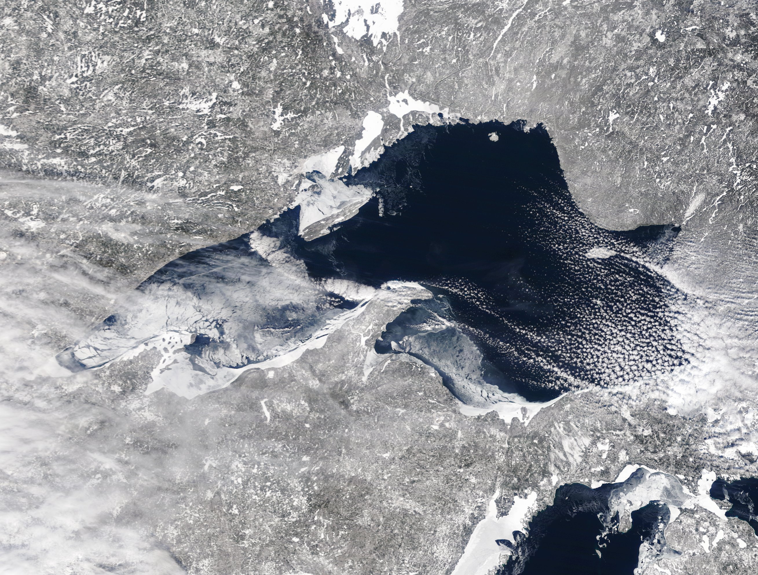 Satellite image of Lake Superior showing a small portion of ice along the shorelines with minimal ice in the middle of the lake.
