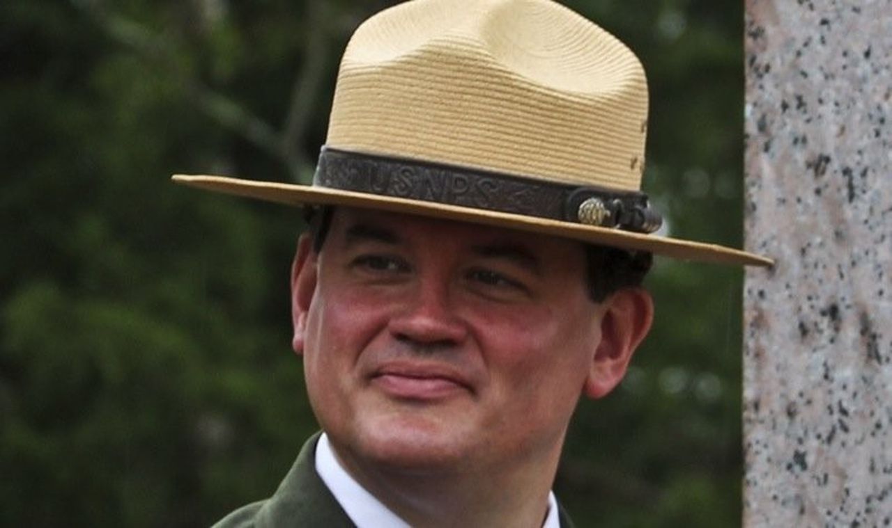 Superintendent Ed Clark wearing a straw NPS flat hat.