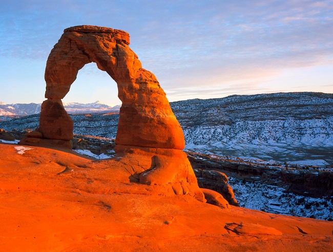 Delicate Arch in Arches National Park in vibrant orange red.