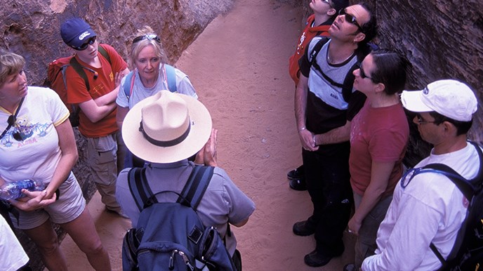 A park ranger with a group of people A park ranger with a group of people