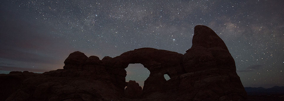 stars above a silhouetted Turret Arch